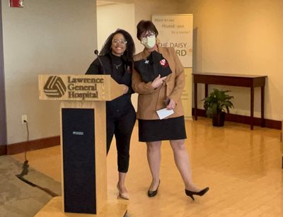 Joanna de Peña, left, presents Lawrence General’s Deborah J. Wilson with a special pair of Top Notch Scholars’ Healthcare Internship Academy scrubs as a token of her appreciation.